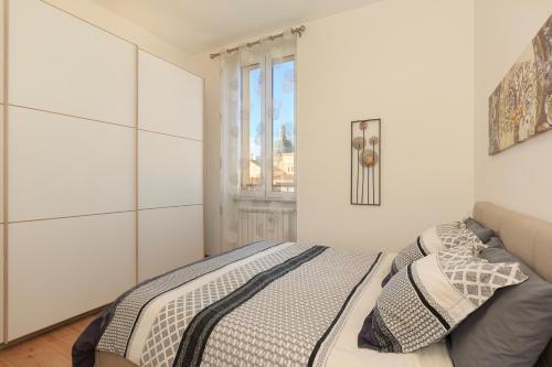 a bedroom with a bed and a window at Nice Flat Milan 50m Station! in Milan
