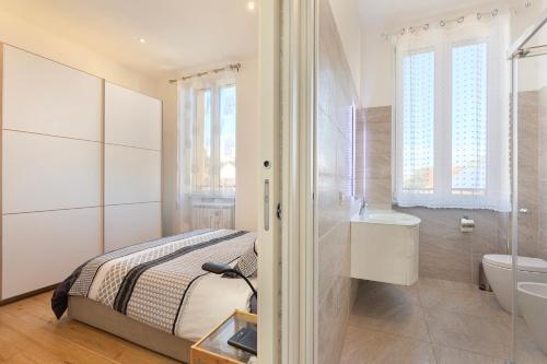 a bedroom with a bed and a sink and a toilet at Nice Flat Milan 50m Station! in Milan