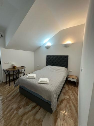 a bedroom with a bed with two towels on it at Olive Luxury Apartments Orebić in Orebić