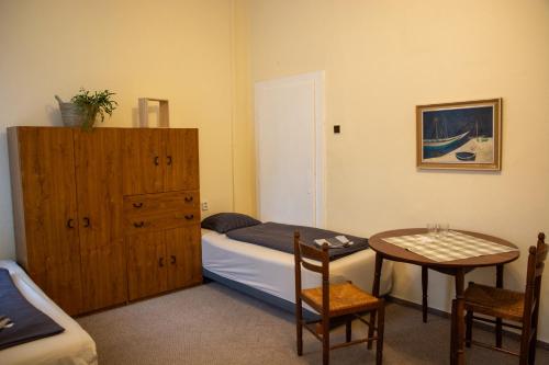 a bedroom with a bed and a table and a cabinet at Hostel Moravia Ostrava in Ostrava