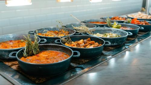 a buffet of bowls of food on a table at Labranda Alyssa Suite Hotel in Playa Blanca