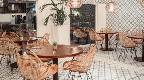 a restaurant with tables and chairs in a room at Labranda Alyssa Suite Hotel in Playa Blanca