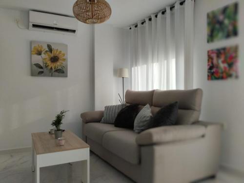 a living room with a couch and a table at Apartamento SUN GATE in Jerez de la Frontera
