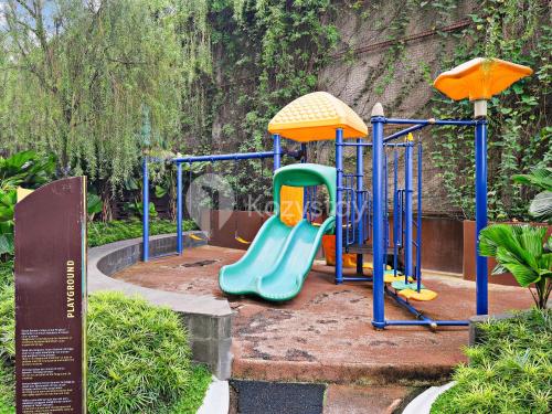 a playground in a park with a slide at Jatayu by Kozystay - Paskal in Bandung