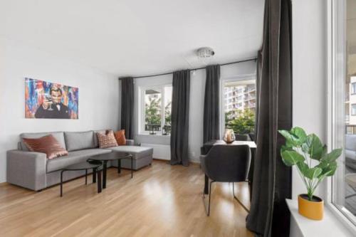 a living room with a couch and a table at Wow, Apartment with great location in Oslo