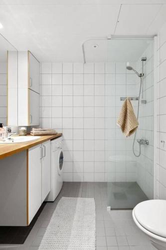 a bathroom with a shower and a sink and a toilet at Wow, Apartment with great location in Oslo