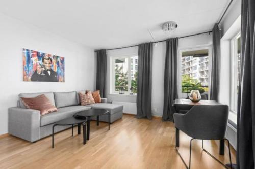 a living room with a couch and a table at Wow, Apartment with great location in Oslo