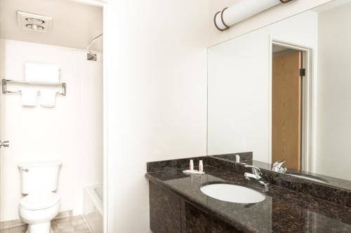a bathroom with a sink and a toilet at Super 8 by Wyndham Salina/Scenic Hills Area in Salina