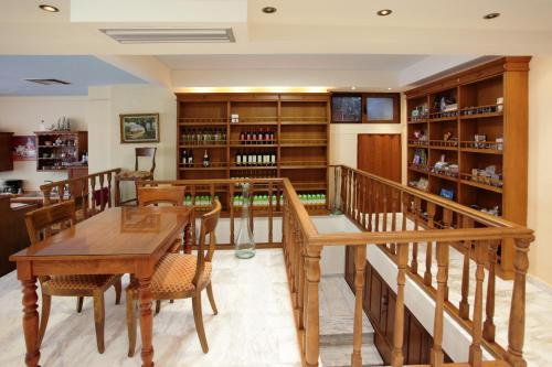 a dining room with a table and chairs and a book shelf at Afroditi in Rethymno Town