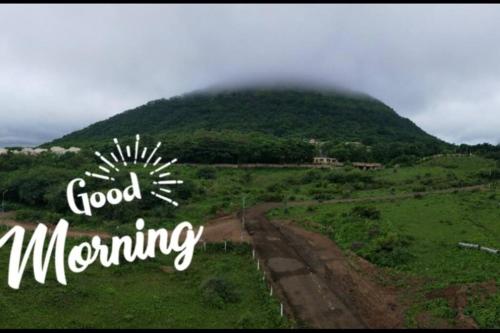 a mountain with the words good morning in the foreground at The Perfect Living Lavish Flat- for Families only in Nashik