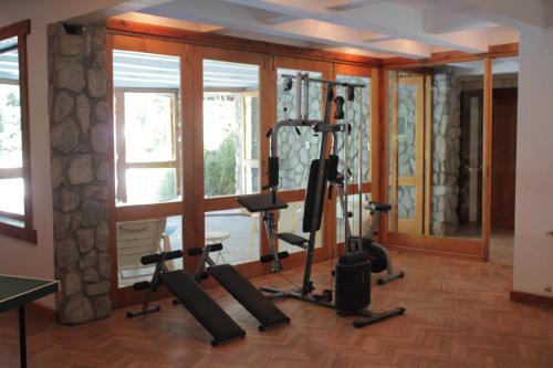 a gym with tread machines in front of a window at Aldea Bonita in Villa La Angostura