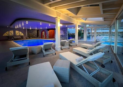 a pool with lounge chairs and a swimming pool at Delta Resort Apartments in Ascona