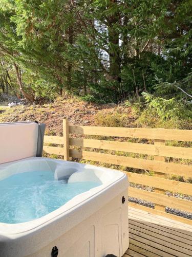 a hot tub sitting on top of a wooden deck at kaoglen Wild-Hot tub-Cairngorms-Pet Friendly in Balnald