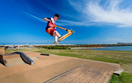 a man doing a trick on a skateboard in the air at Discovery Parks - Harrington in Harrington