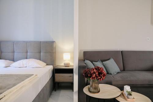 a bedroom with a bed and a couch and a table at Ολυμπία in Xanthi