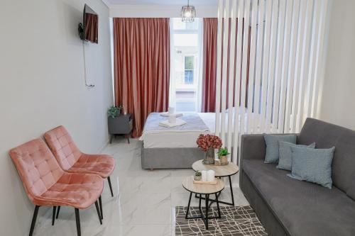 a living room with a couch and a bed at Ολυμπία in Xanthi