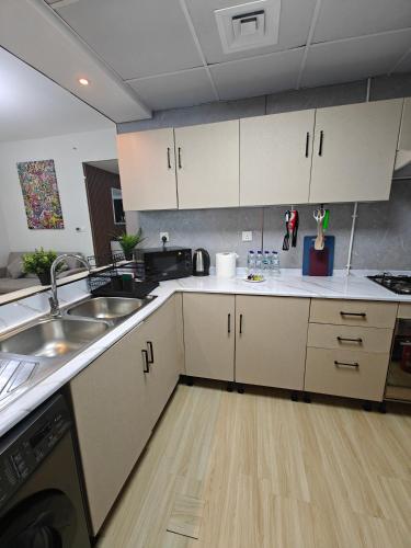 a kitchen with white cabinets and a sink at Marina View Spacious 2 BHK in Dubai