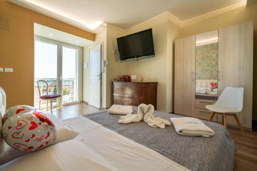 a bedroom with a bed with two towels on it at Vista Mare Apartments in Giardini Naxos
