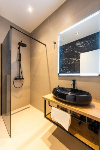 a bathroom with a black sink and a shower at ADRIAN LUXURY 5 Star in Dubrovnik