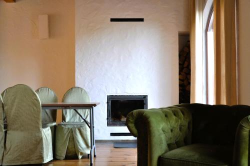 a living room with a couch and a fireplace at Dom nad Rozlewiskiem in Zamość