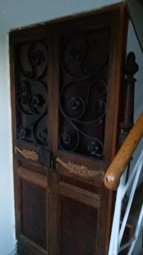 a wooden cabinet with a glass door on a staircase at Villa Fiorita in Monfalcone