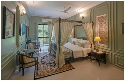 a bedroom with a canopy bed and a balcony at Luxury Heritage Umaid 3BHK Apartment Jodhpur in Jodhpur