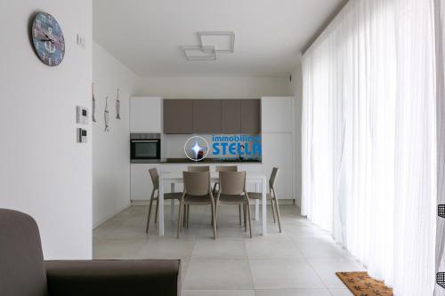 a kitchen and dining room with a table and chairs at Cala Blu in Lido di Jesolo