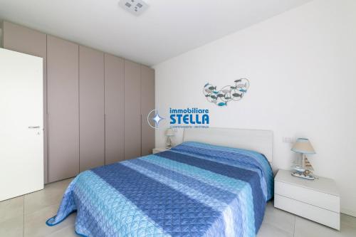 a bedroom with a bed and a sign on the wall at Cala Blu in Lido di Jesolo
