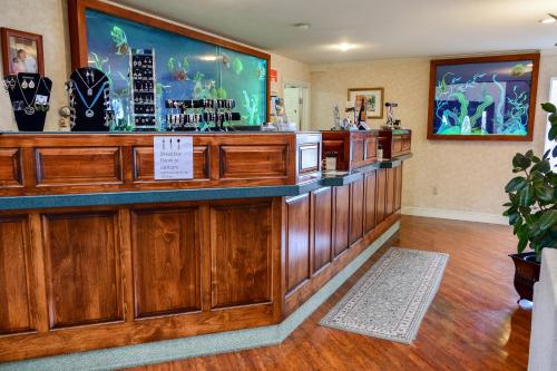 a bar in a restaurant with a large screen at North Cliff Hotel in Fort Bragg