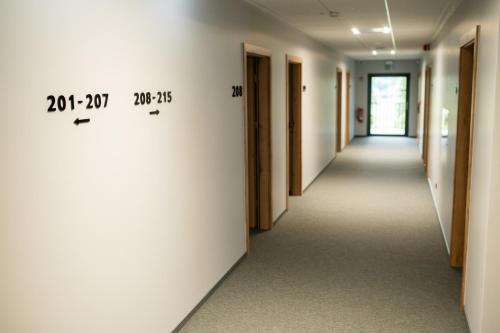 a corridor of an office building with a hallway at Hotel Igloo in Krotoszyn