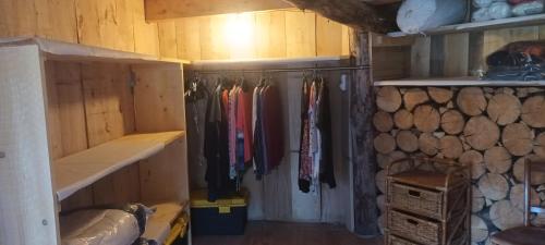 un placard dans une cabine avec des vêtements suspendus à des crochets dans l'établissement Le Pré Soutro, à Arches
