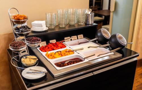 a buffet with a bunch of food on a table at Hotel Elite Prague in Prague