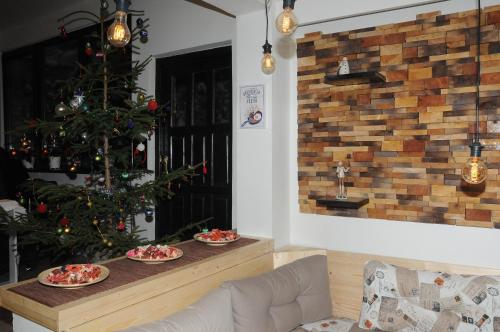 a living room with a christmas tree and plates of food at AS Apartments in Kopaonik