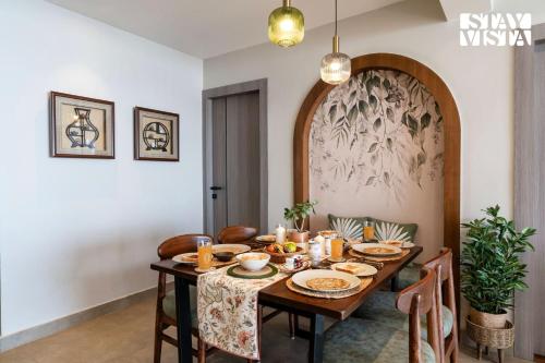 a dining room with a wooden table and chairs at StayVista at Ember Home with Balcony, Meals Available in Mussoorie