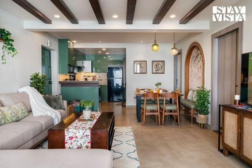 a living room with a couch and a table at StayVista at Ember Home with Balcony, Meals Available in Mussoorie