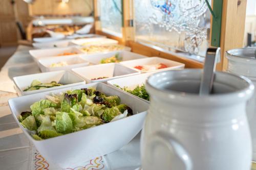a table topped with trays of food and a cup of coffee at Hotel Tauernblick in Obertauern