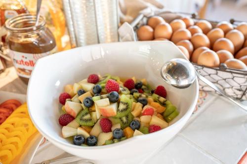 a bowl of fruit on a counter with eggs at Hotel Tauernblick in Obertauern