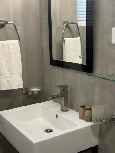 a bathroom with a white sink and a mirror at Sapiens home - Weligama bay in Weligama