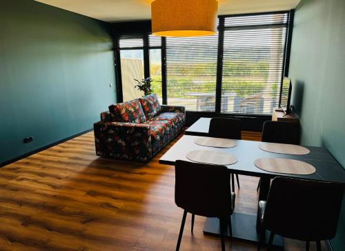 a living room with a table and a chair at Longstay Achterhoek in Zeddam