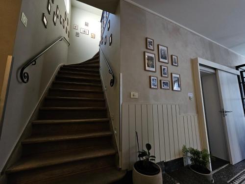 a hallway with stairs with pictures on the wall at Guesthouse Bonheure in Bruges