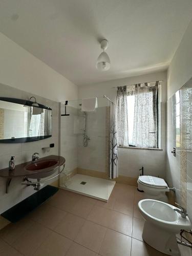 a bathroom with a sink and a toilet at Affittacamere Karma Rho-Fiera in Rho