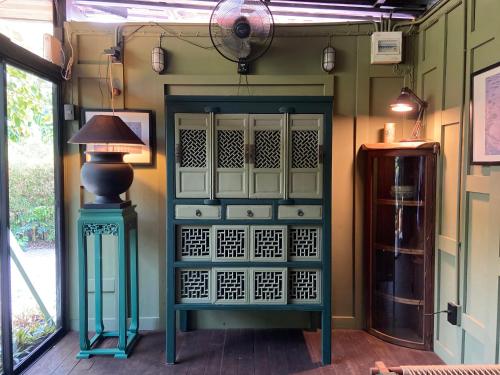 a room with a door with a lamp next to it at Mintys Folly 2 in Ban Man