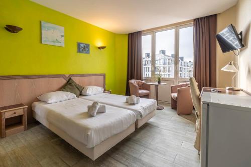 Postel nebo postele na pokoji v ubytování Sleep & Go Blankenberge