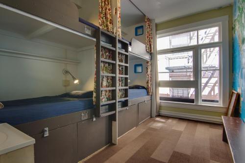 a room with two bunk beds and a window at Adelaide Hostel in San Francisco