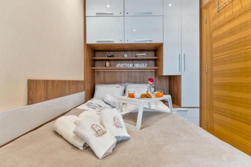 a bedroom with a bed with a table on it at Apartman Mihajlo Kalman in Zlatibor