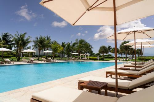 a pool at the resort with lounge chairs and umbrellas at Aurora Anguilla Resort & Golf Club in Rendezvous Beach