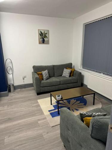 a living room with two couches and a large screen at Nice house with free Parking in Newcastle upon Tyne