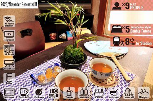 a table with two cups of tea and a plant at Oyado Shogoin in Kyoto