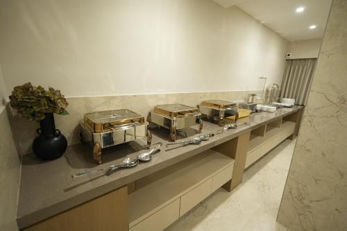 a counter with a bunch of pans on it at SIVANTA by BOMBAY GROUP OF HOTELS NAGPUR in Nagpur
