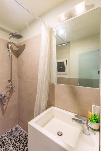a bathroom with a sink and a shower at AIOLOS glyfada centre apartment 1 in Athens